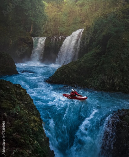 Person kayaking on waterfalls photo