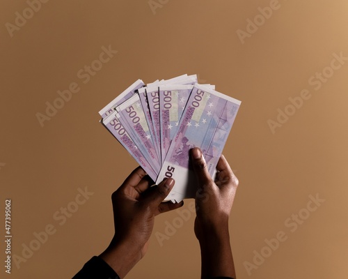 Person holding fan of five hundred Euro banknotes