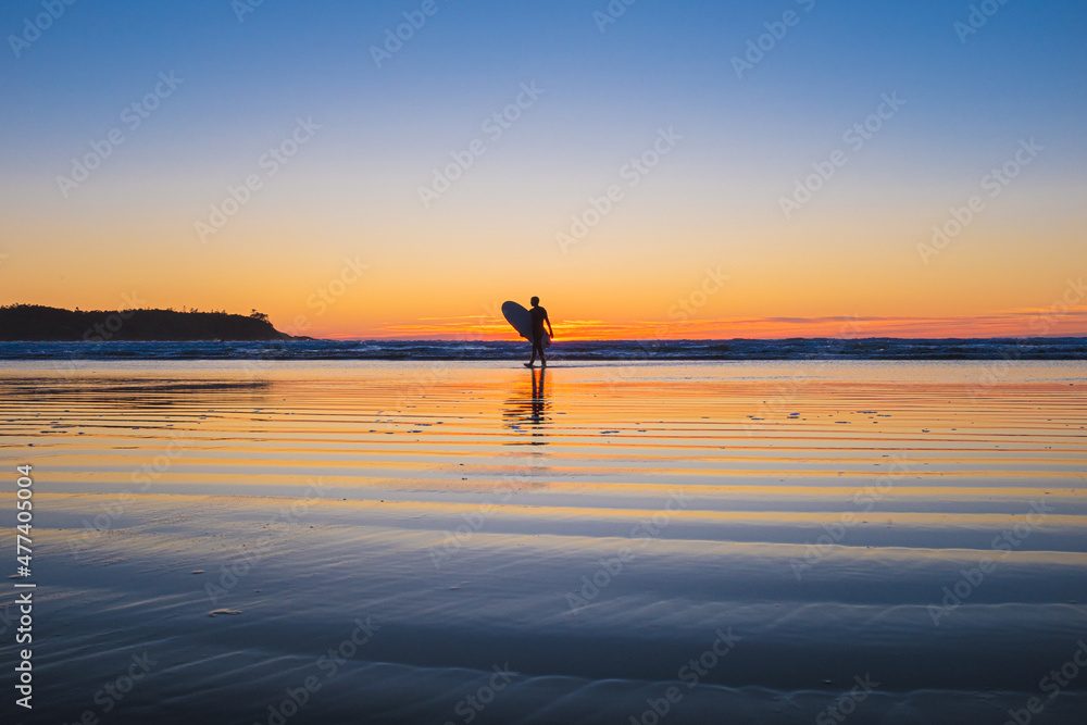 silhouette of a surfer on the beach
