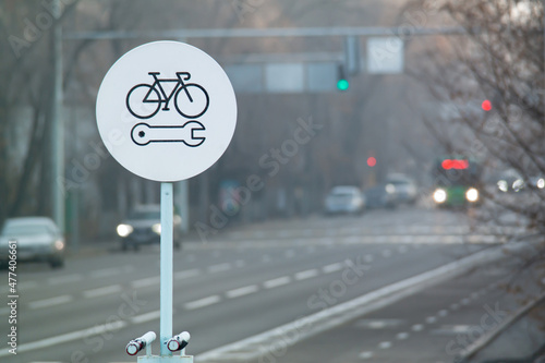 Bicycle repair round white sign on a bike lane. Bike self repair station