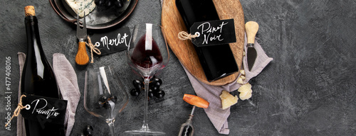 Foto Red wine assortment with appetizers on gray background.