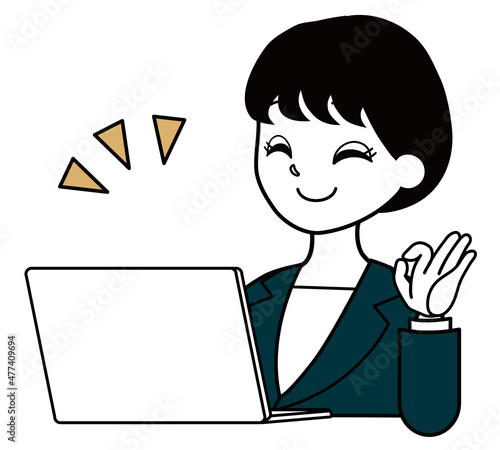 パソコンを見てOKサインを出すスーツを着た女性会社員