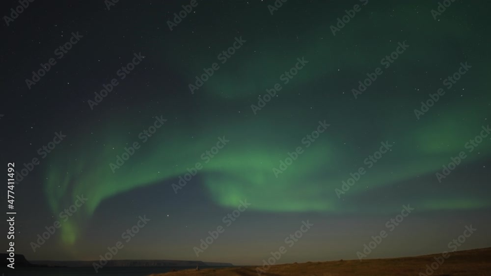 The beautiful show of the northern lights in the starry night sky above the desolate tundra landscape. The beautiful show of the northern lights in the starry night sky above the desolate tundra landscape.