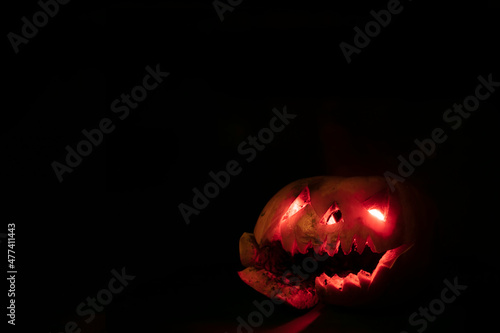Glowing halloween pumpkin on a black background.