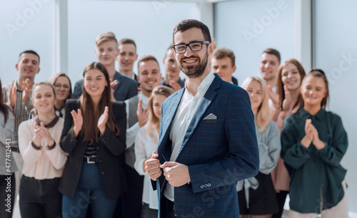 Manager and a group of diverse employees standing in the new office