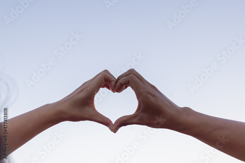 Valentine couples use their hands to make heart symbols to symbolize friendship and loving-kindness towards their lover and friends because heart symbols signify love, friendship and kindness.