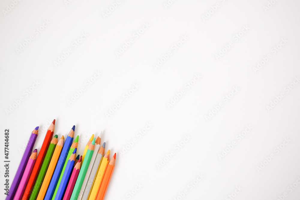Fototapeta premium Colored pencils on a white background. Place for your text. Copy space. Mockup