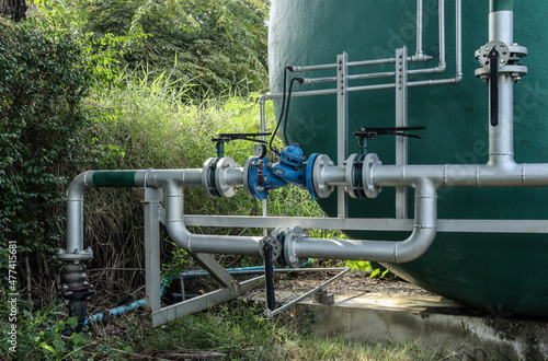 Wallpaper Mural The joints and steel pipes transporting water up to a large water tank. Torontodigital.ca
