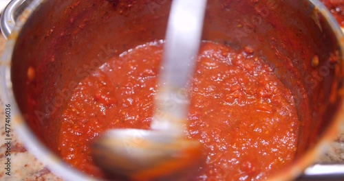 Close up view of homemede tomato sauce boiling in a pan, being stirred with a spoon. Hot tomato sauce cooked for pizza or pasta. 4K video.
4K photo
