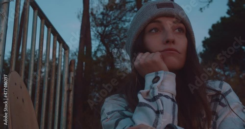 Close up gimbal shot of beautiful girl looking into distance during sunset photo