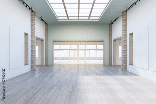Modern concrete exhibition hall interior with wooden flooring  empty posters and sunlight. Gallery concept. 3D Rendering.