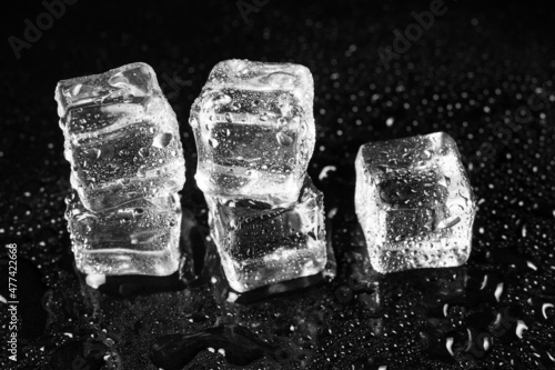 ice cubes on black table background.