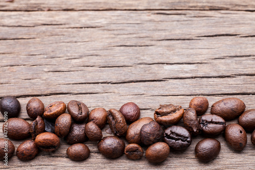 Coffee beans on old wooden floor background..