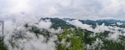 Aerial view of a cloud shrouded village with terraces