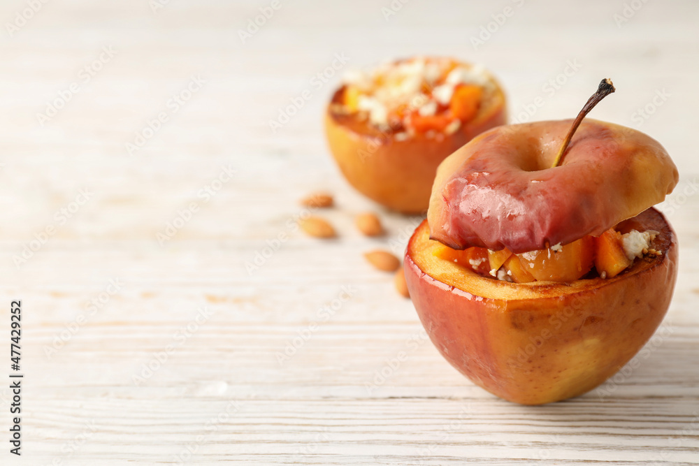 Concept of tasty food with baked apple on wooden background