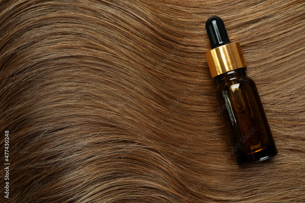 Naklejka premium Dark female hair with cosmetic on whole background