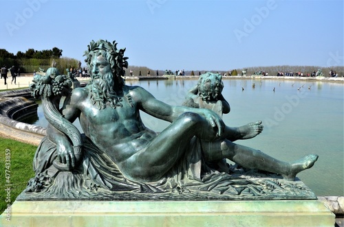 Statue in the gardens of Versailles Palace, Paris (France)
