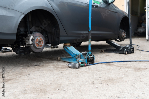 car on jacks for a hundred, changing wheels and checking suspension elements