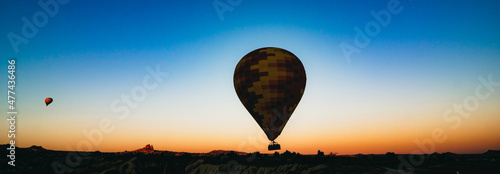 Fotografie, Obraz Hot Air Balloon banner. Silhouette of Hot Air Balloon at sunrise.