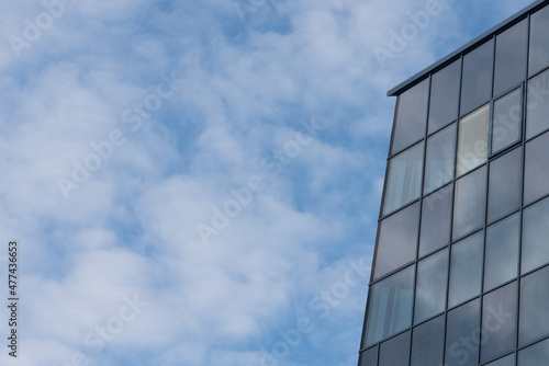 Photo of an element of a business building against a blue sky background.