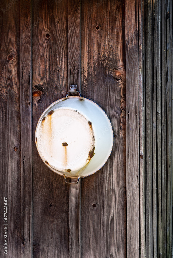 White Metal Tub Hanging on Wood Wall White Metal Tub Hanging on Wood Wall