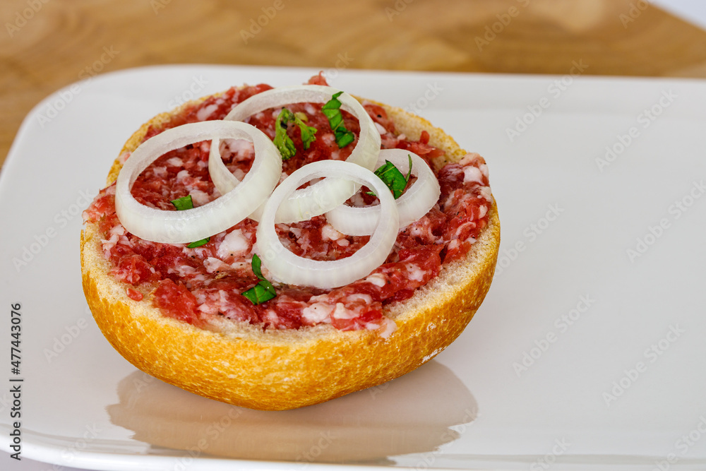 A bun with fresh minced pork meat A bun with fresh minced pork meat