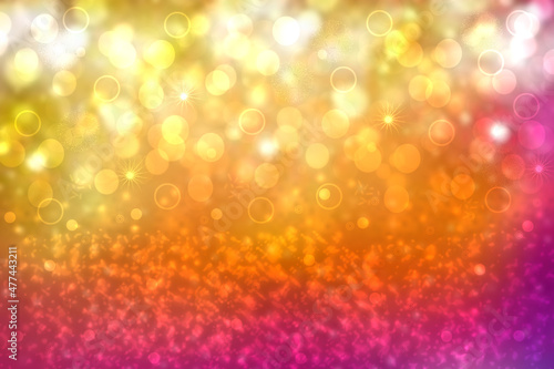 A festive abstract delicate Happy New Year or Christmas background texture with colorful gold yellow pink blurred bokeh lights and stars. Space for design. Card concept or advertising.