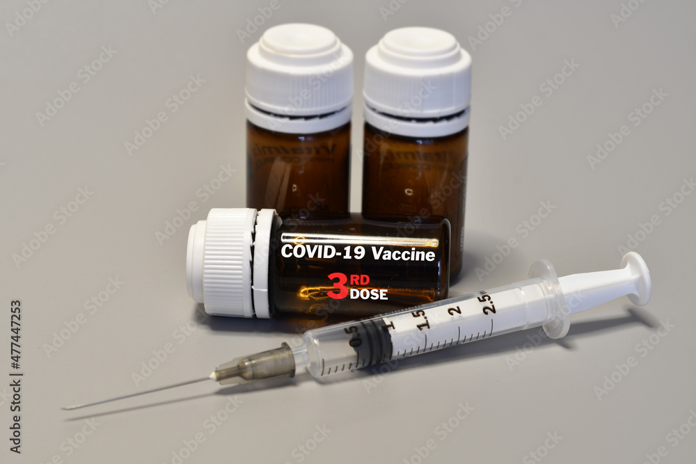 Syringe with Covid-19 Vaccine Booster Dose. Fight against virus covid-19 coronavirus, Vaccination and immunization. diseases,medical care,science, vaccine booster concept. Syringe with Covid-19 Vaccine Booster Dose. Fight against virus covid-19 coronavirus, Vaccination and immunization. diseases,medical care,science, vaccine booster concept.