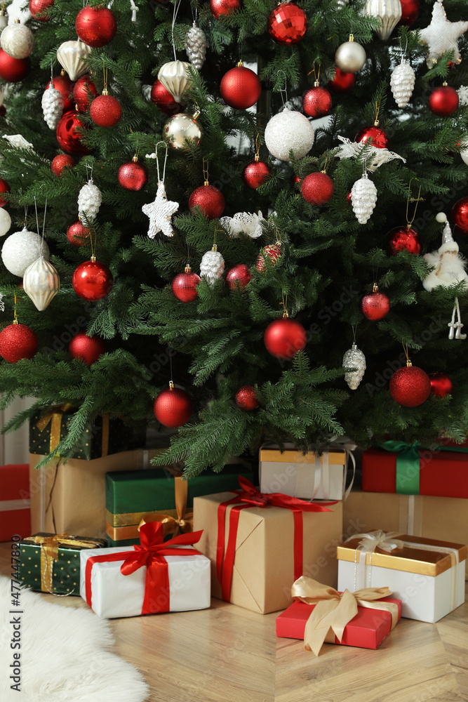 Beautifully decorated Christmas tree and gifts indoors