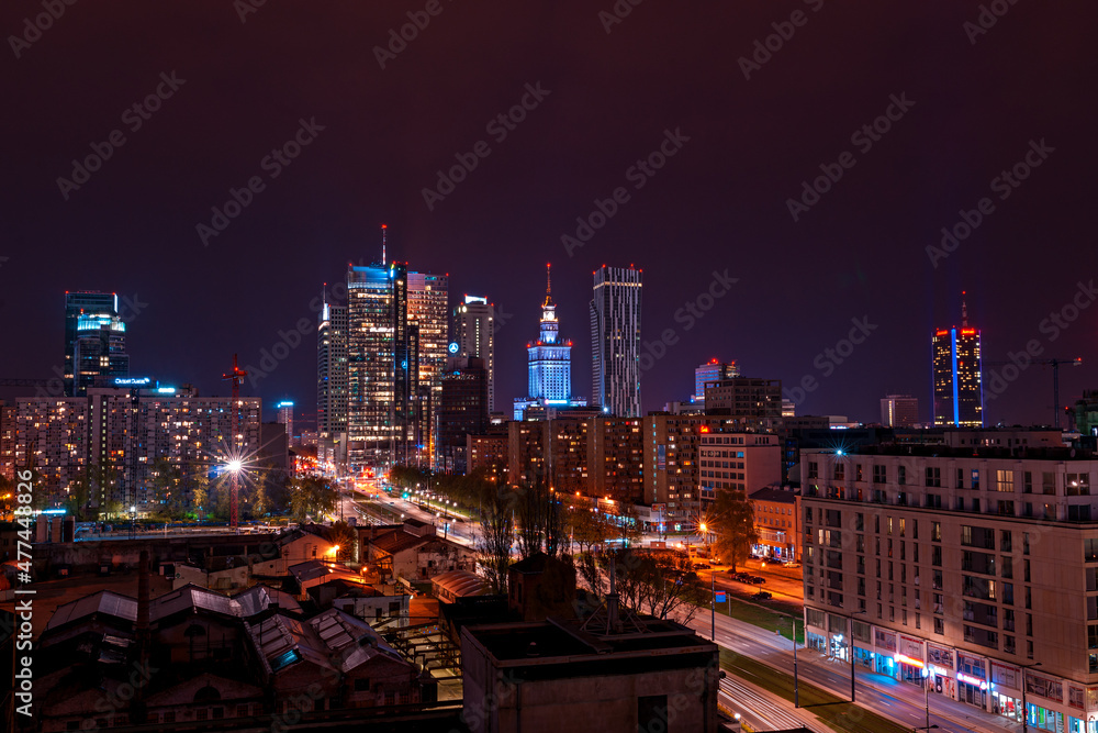 photo of a city at night with a lot of light from buildings