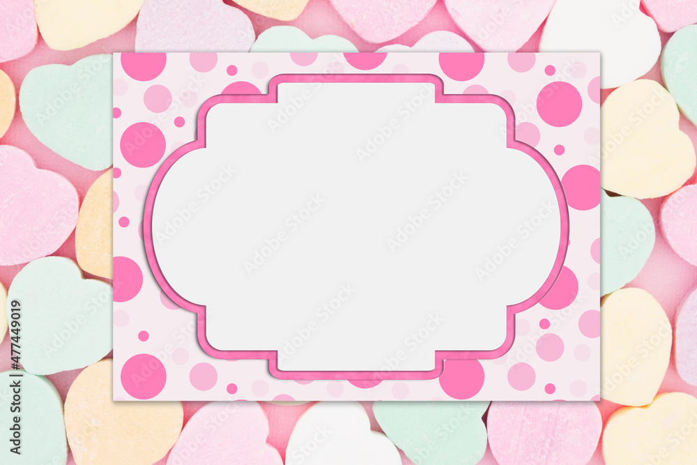 Blank pink polka dot greeting card over candy hearts Blank pink polka dot greeting card over candy hearts