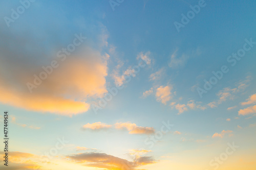 clouds and yellow sky,Sky background at sunset,Sky blue and orange light of the sun through the clouds in the sky © banjongseal324