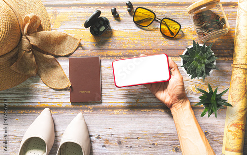 Plan a trip with a tablet,Plan a trip with a tablet,Packed suitcase of vacation items, top view,Tablet blank for mockup ecommerce concept with paying money by use credit card 