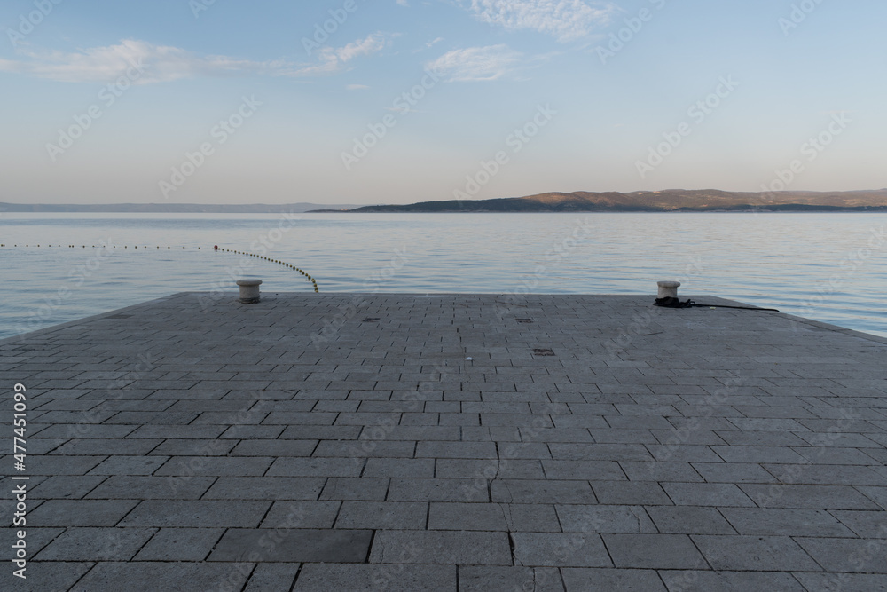 Stone dock in Adriatic sea near Baska Voda, Croatia at summer morning