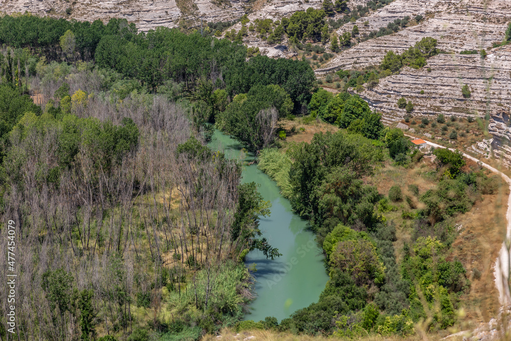 View of the Jucar river passing near the town Alcala del Jucar in Spain