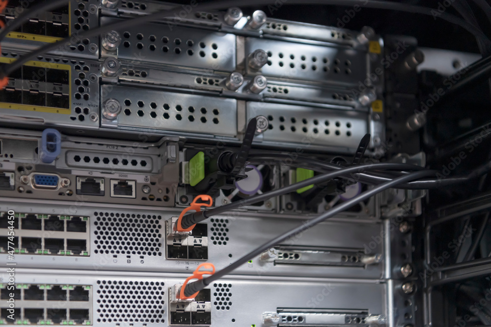 network server room closeup on fiber optic hub or switch for digital communications and internet in mainframe corporate business data center supercomputer. network server room closeup on fiber optic hub or switch for digital communications and internet in mainframe corporate business data center supercomputer.
