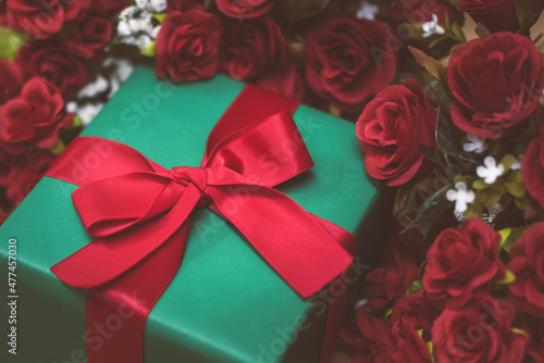 Romantic still life, Red roses with present on a wooden background. Fragrant red flowers, gift concept for Valentine's Day, Wedding or Birthday. Soft focus. any day to say I love you.