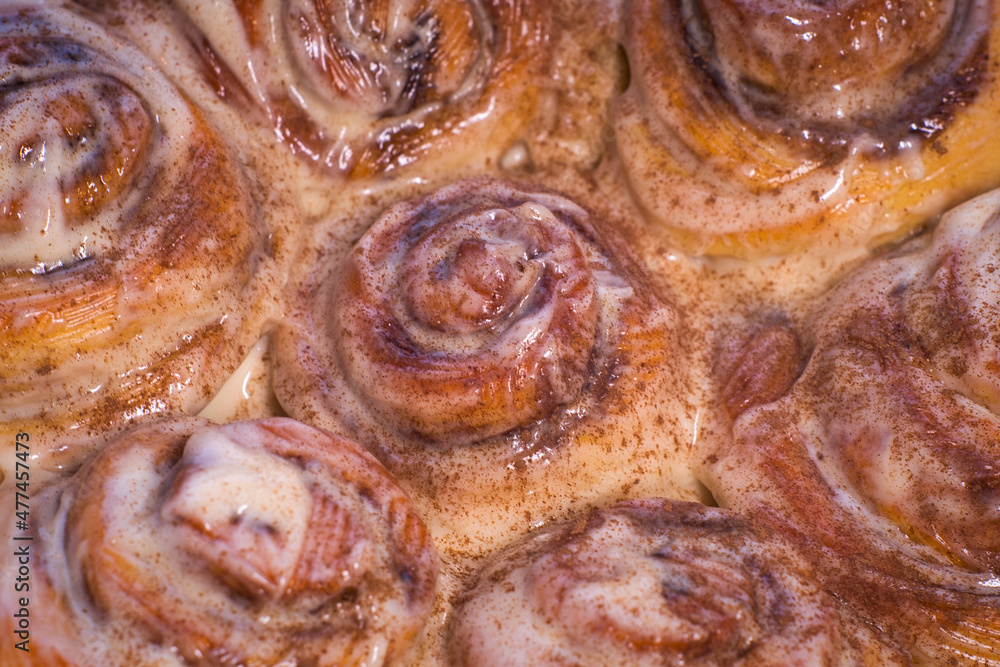 Fototapeta premium Delicious cinnamon roll buns with cheese glaze
