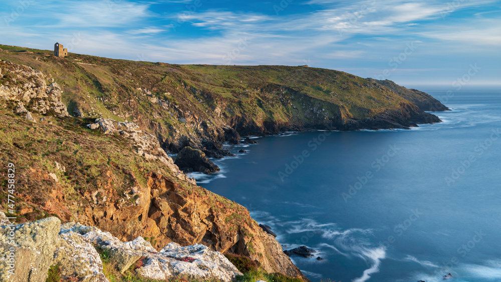 The Cornish coastline, near Lands end. The day is sunny. There are ruined tin mines dotted along the cliff edge The Cornish coastline, near Lands end. The day is sunny. There are ruined tin mines dotted along the cliff edge