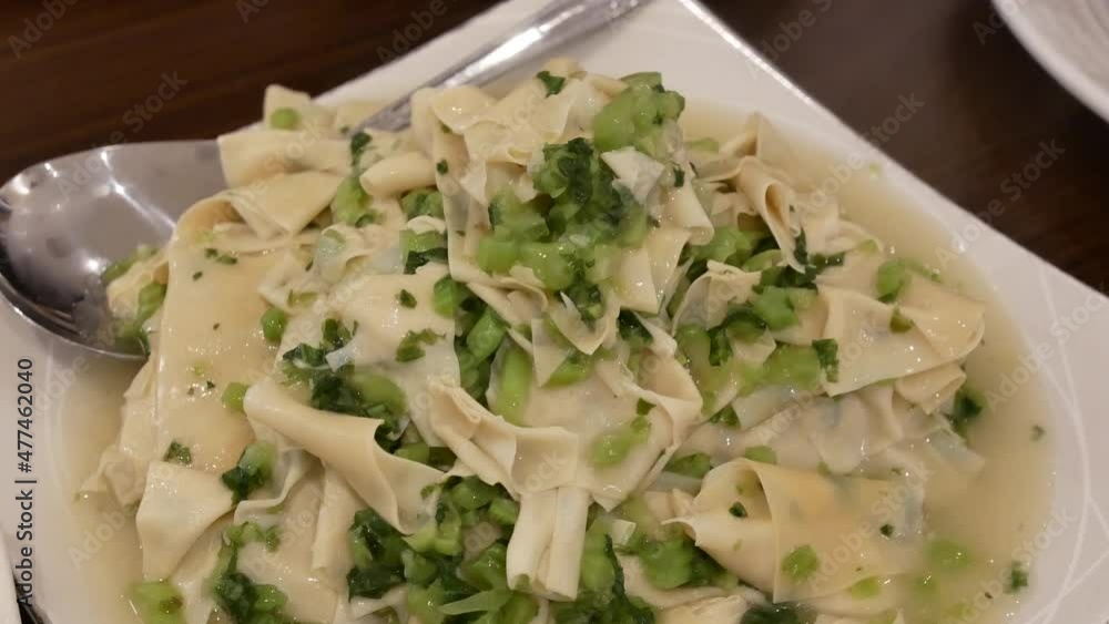 The motion of Stir-fried vegetables with tofu skin on a plate with steam inside Chinese restaurant 4k resolution. The motion of Stir-fried vegetables with tofu skin on a plate with steam inside Chinese restaurant 4k resolution.