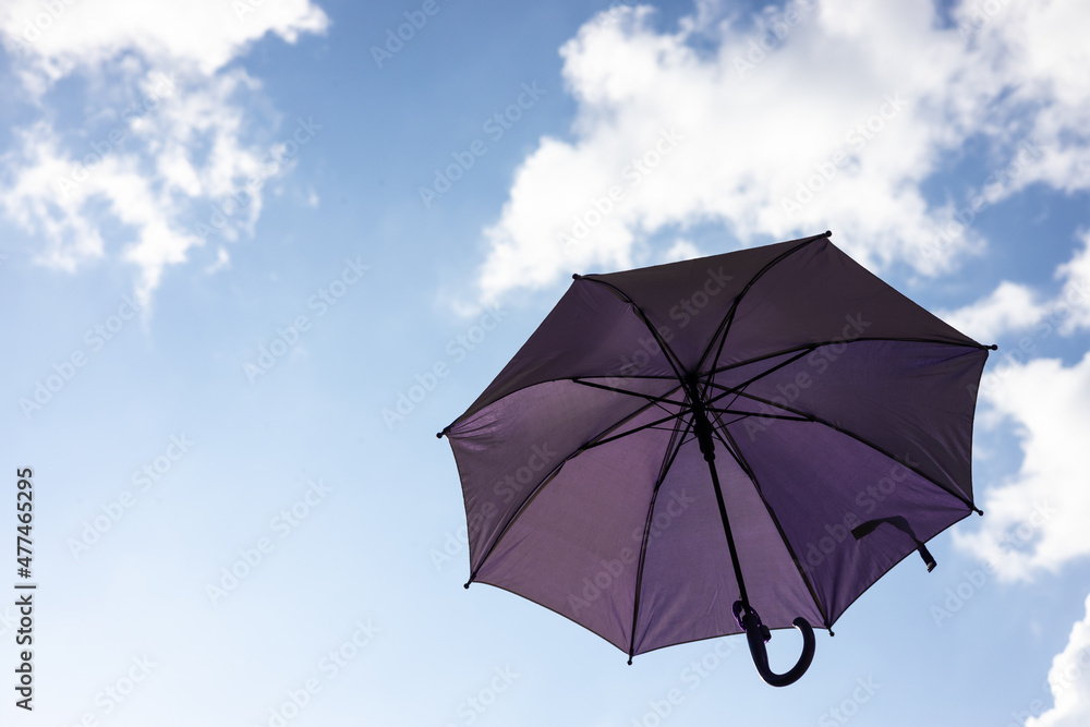 A close-up view from the low, a beautiful purple umbrella floating freely.