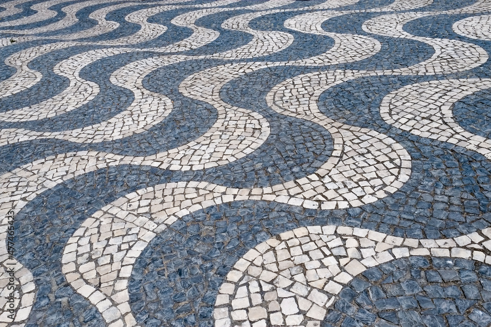 Black and white tiled cobblestone sidewalk. Cascais, Portugal
