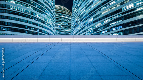 Panoramic skyline and modern commercial office buildings with empty square floors in Beijing at night
