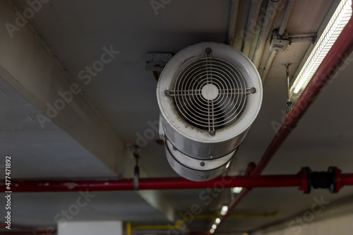 Fan in modern building Parking in door. Parking building ventilation system. blower flow air for confined space work in factory. Industrial Fan Heater and Cooler.