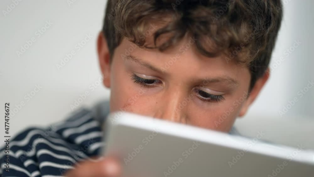 Child amazed reaction to content online. Excited wide open mouth kid holding tablet Child amazed reaction to content online. Excited wide open mouth kid holding tablet