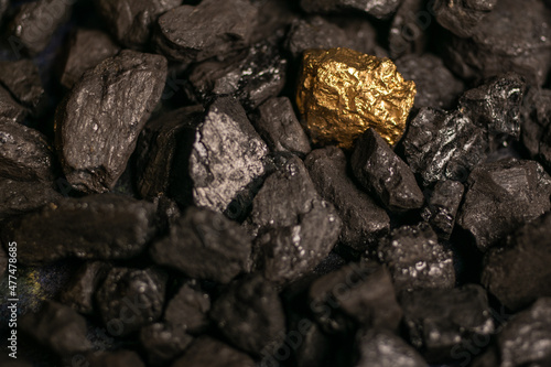 hard coal in the pile. a piece of gold among the coal. extracted underground.