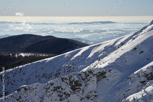 Steep snowy slopes of Kotel Mountain with panoramic view of Giant Mountains, winter pure nature landscape
