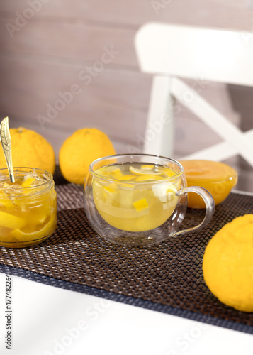 Yuzu tea made from yuzu jam and honey. Yuja-chhong is a marmalade made from yuzu zest, juice and honey. photo