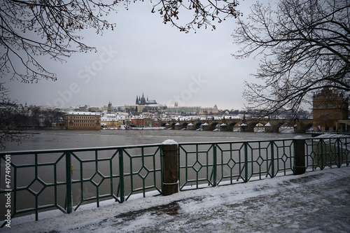 Beautiful Prague historic center with Charles Bridge and Castle in winter snow, no people, Czech Republic © Milan