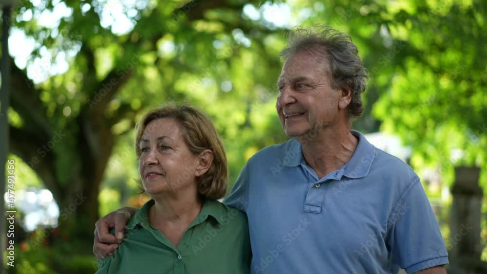Happy senior couple walking together outside, older 60s people relationship Happy senior couple walking together outside, older 60s people relationship